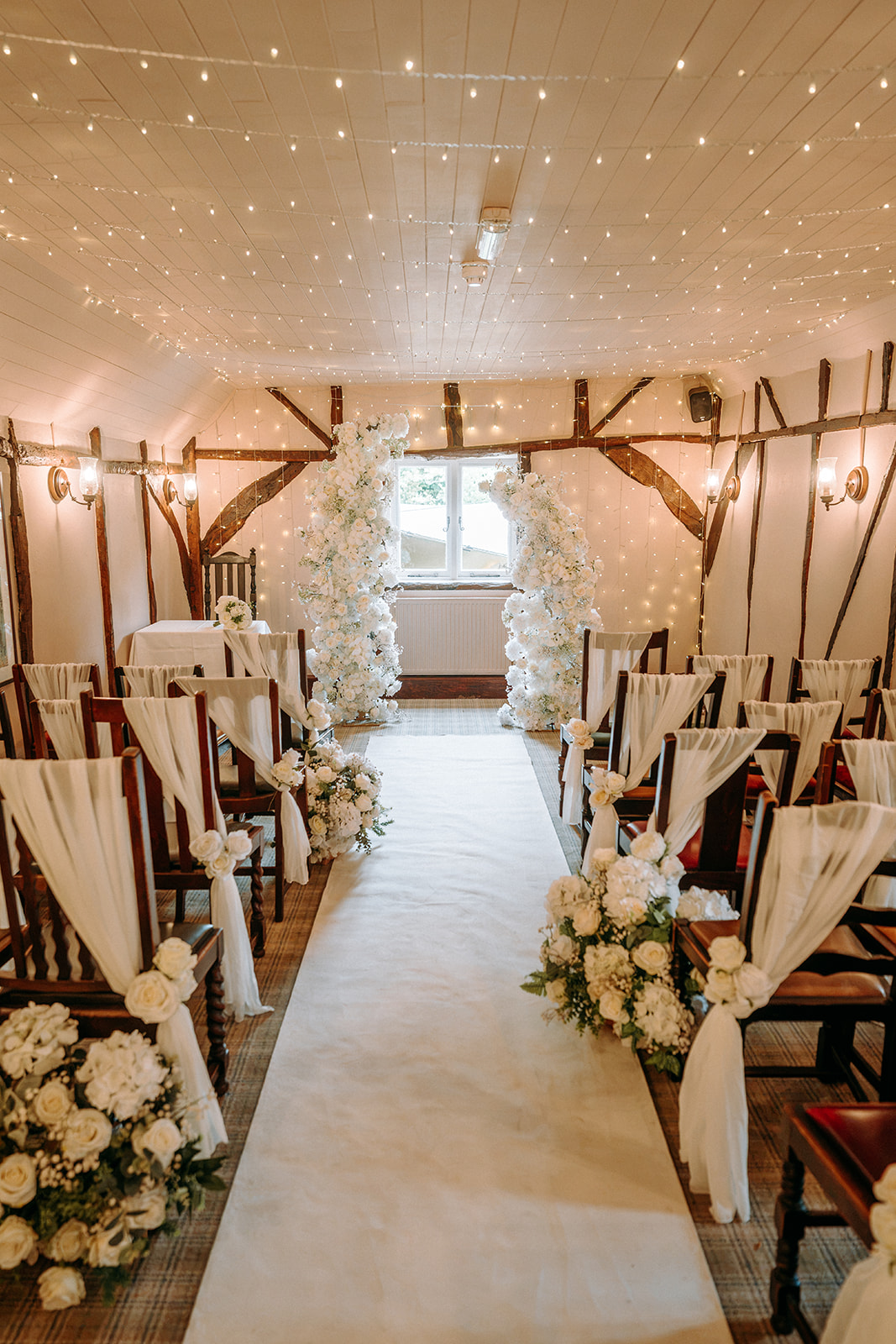 Elegant wedding ceremony setting decorated with beautiful artificial flowers